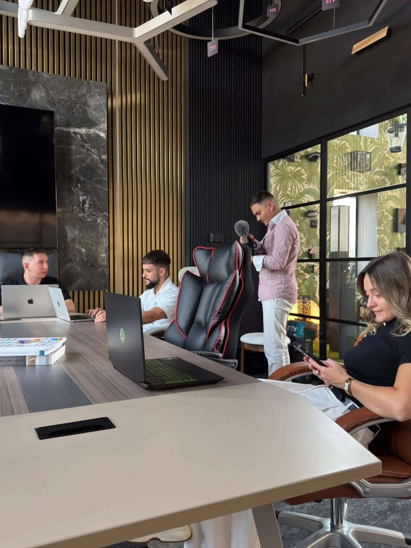 A working session with laptops and video production equipment
